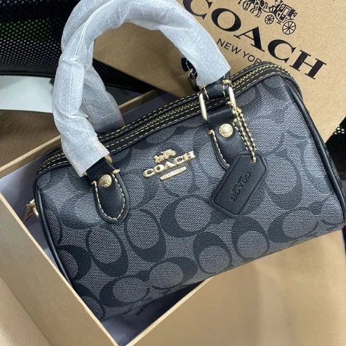 24.png Front view of Coach Mini Rowan Crossbody Bag in signature canvas