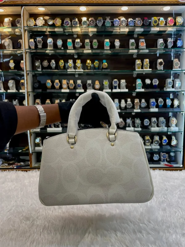 6XDeahVy.jpg Coach sling bag for girls in white body - front view