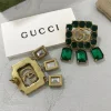 GG Crystal Studded Drop Earrings close-up view