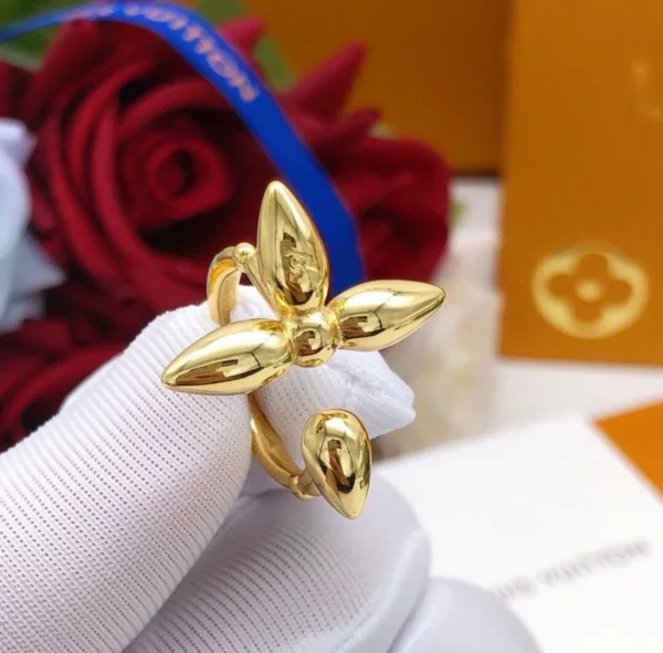 WhatsAppImage2026-04-13at3.54.03PM.jpg Elegant LV Gold Flower Ring displayed on a velvet background