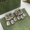 GG Crystal Studded Drop Earrings close-up view
