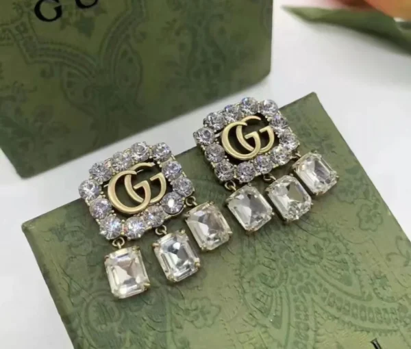 GG Crystal Studded Drop Earrings close-up view
