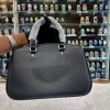 intgWUbG.jpg Front view of Coach sling bag for girls in black