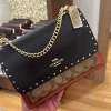 photo_2025-11-22_14-00-26_7.jpg Klare Crossbody Bag in Signature Canvas with Rivets - Front View