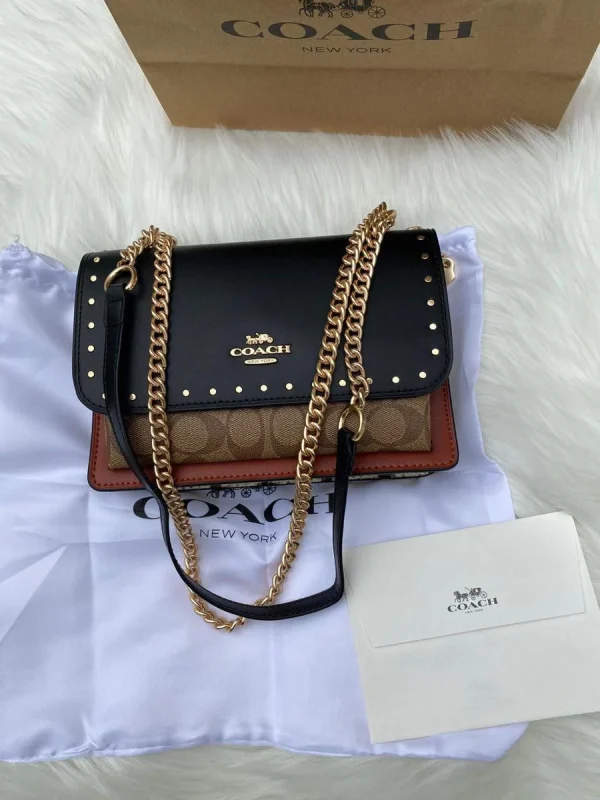 photo_2025-11-22_14-00-26_8.jpg Klare Crossbody Bag in Signature Canvas with Rivets - Front View